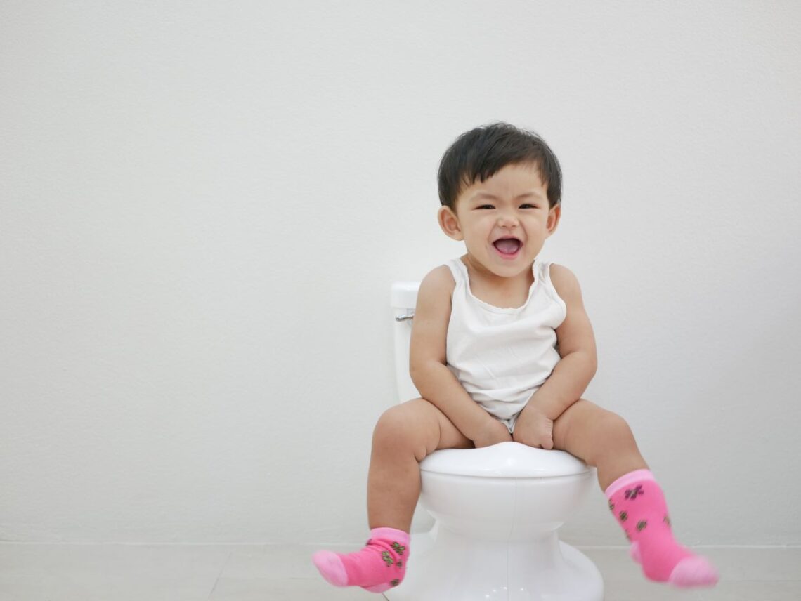 Toddler sitting on potty